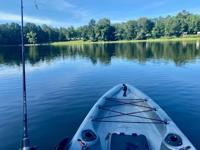 Fishing kayak in lake - view of RV park